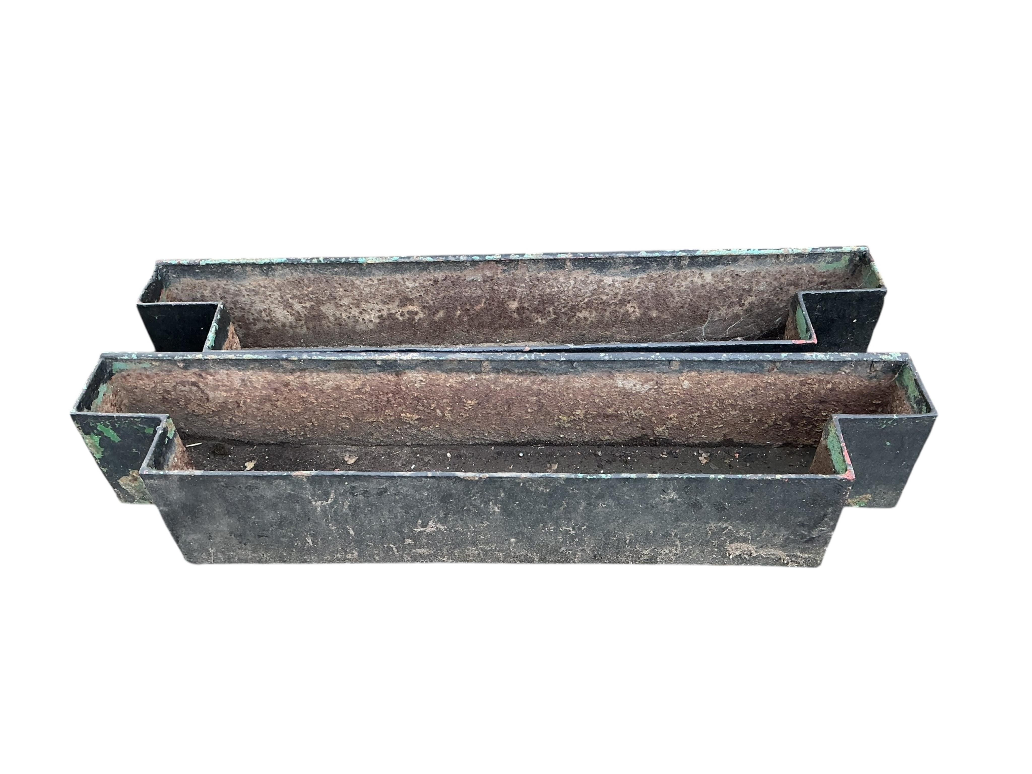 A pair of cast iron planters, width 143cm, depth 28cm, height 26cm